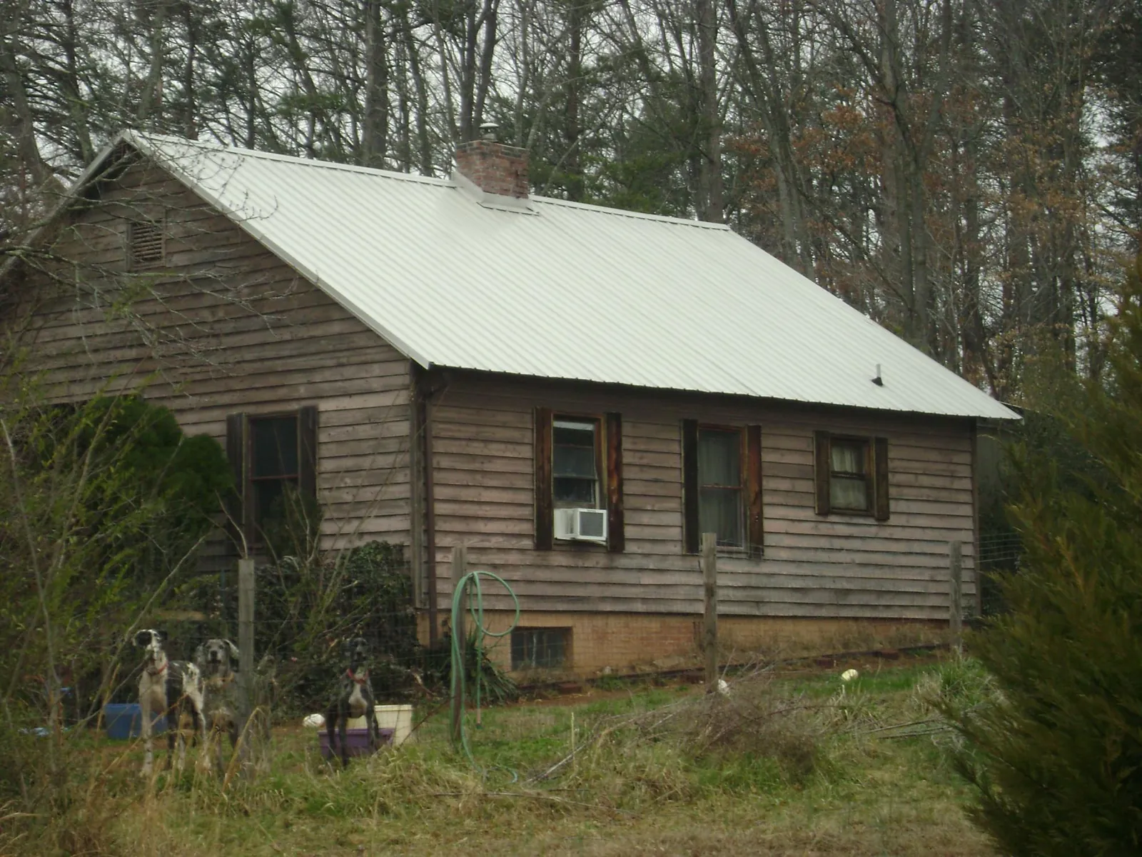 White metal roof on an old wood sided farmhouse, from a Metal Roof Installation job in Wilkes Barre